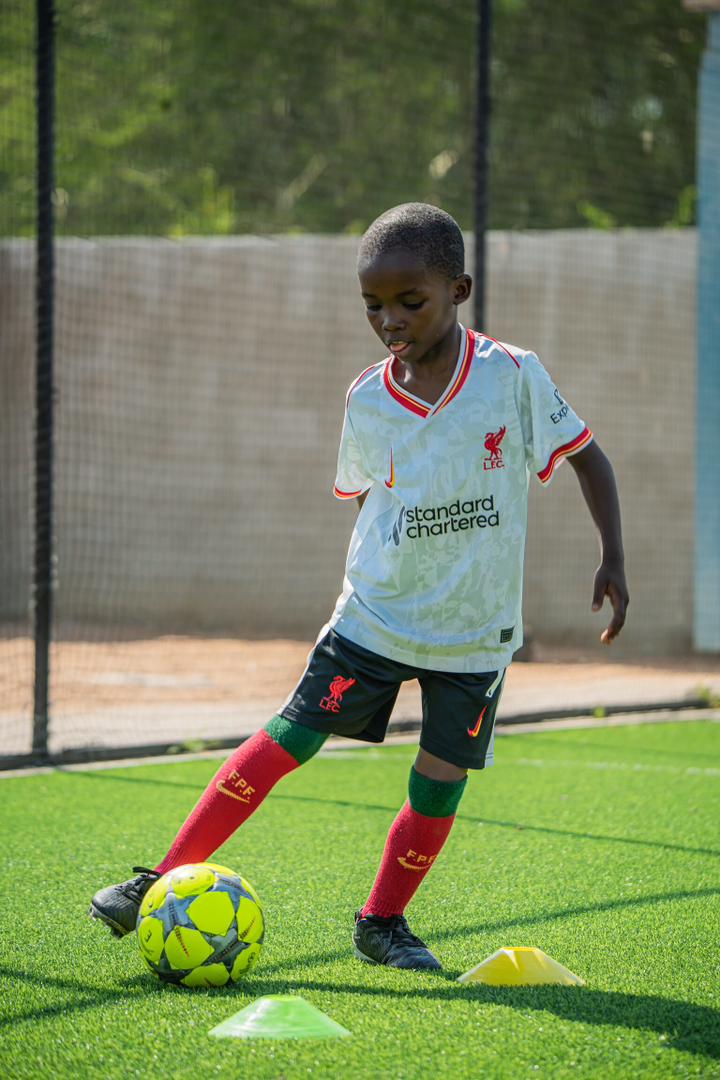Under 10 player controlling the football