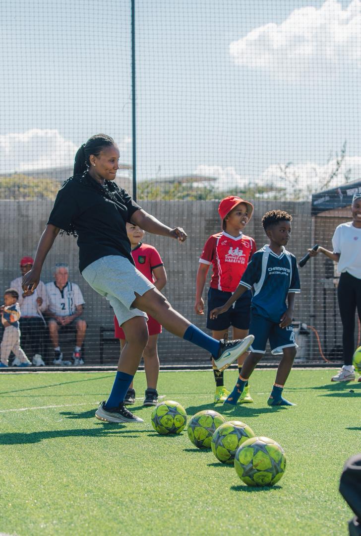 Children and community members enjoying football activities together