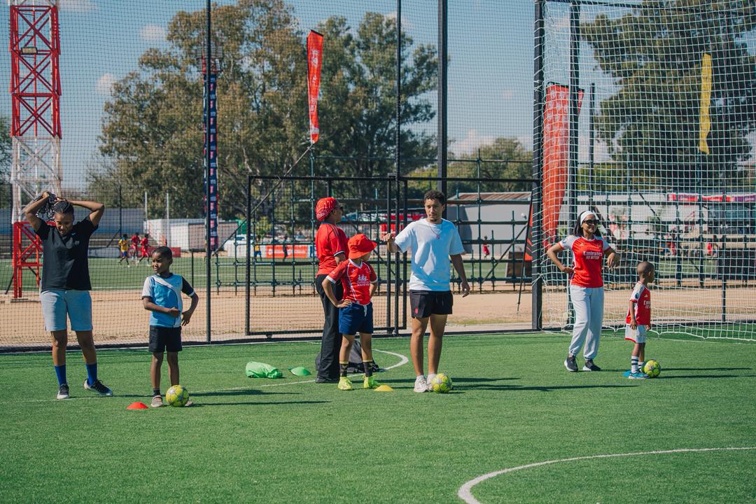 Real United coaches and young players taking part in a community training session